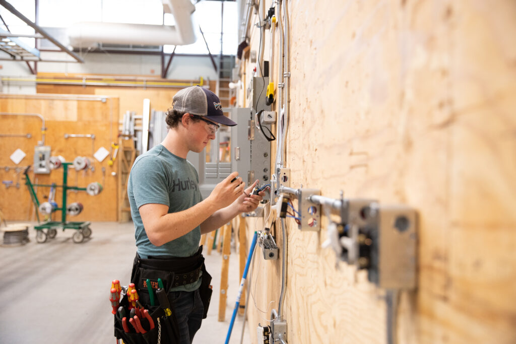 A student works on some wiring in the Trades and Technology building.