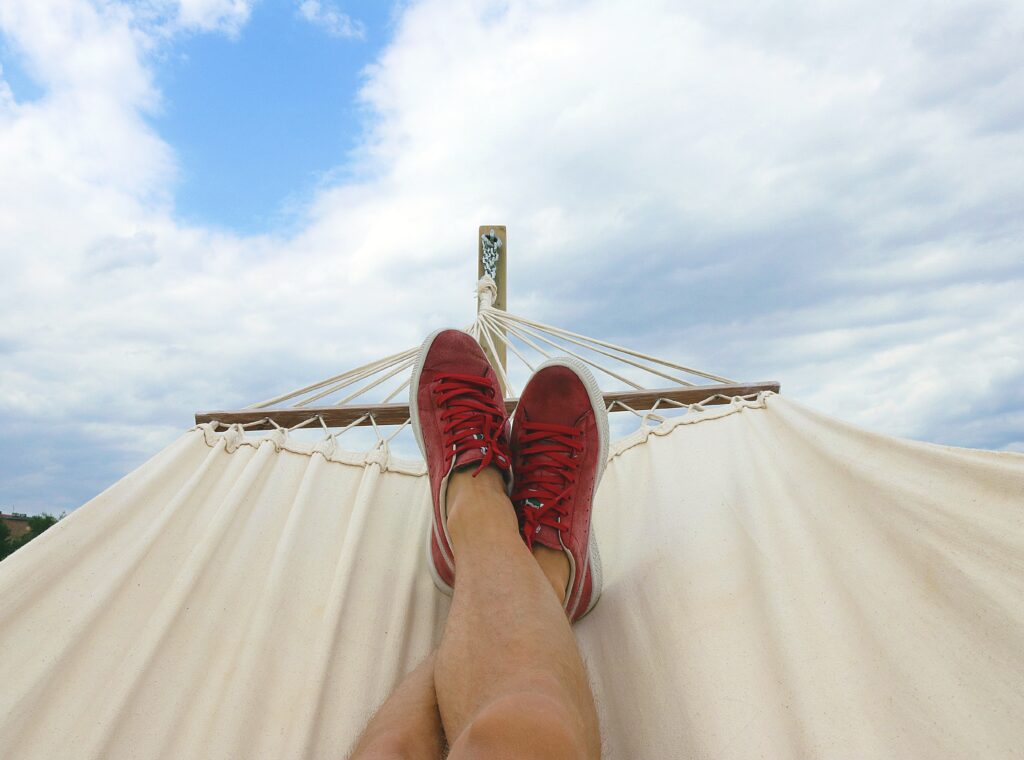 Image of a pair of legs crossed in a hammock.
